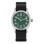 Front view of a Militado ML12 field watch with green dial, silver-tone case, and black nylon strap on white