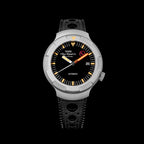 Front view of a Thorn T011 watch with black dial, orange minute hand, silver-tone case, and black perforated strap on black